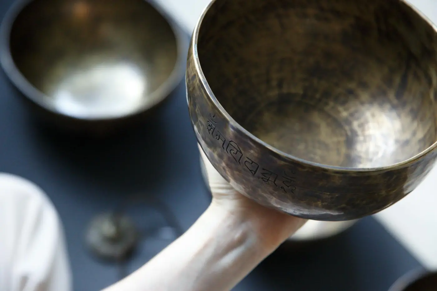 Hands holding a singing bowl